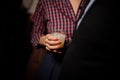 Woman dressed in plaid shirt holding a glass with summer cocktail Royalty Free Stock Photo