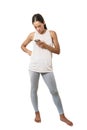 Woman dressed in sportswear looking at her smart phone on a white background Royalty Free Stock Photo