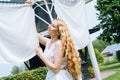 Woman dressed on traditional Dutch dress wooden shoes yellow clogs hanging Clothes on clothesline outside. laundry Royalty Free Stock Photo