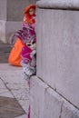 Woman dressed up as jester in pink costume posing at the San Giorgio Maggiore Church on San Giorgio island during Venice Carnival Royalty Free Stock Photo