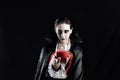 Woman Dressed Up As A Vampire For Halloween Holding Glass Of Red