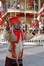 Woman dressed in vintage costume and scary mask at Russian national festival `Shrove` in Moscow