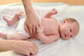 The woman dresses to the baby a diaper Royalty Free Stock Photo