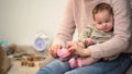 Woman dressing little cute infant girl in pink socks, natural clothing materials Royalty Free Stock Photo