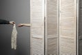 Woman in dressing room stall, the man's hand submits dress