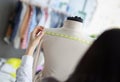 Woman dressmaker measuring on mannequin back for further sewing