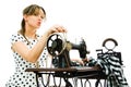 Woman dressmaker pin up style using antique sewing manual machine