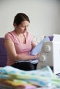 Woman dressmaker working sewing machine. the process of creating clothes at home Royalty Free Stock Photo