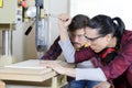 woman drilling piece wood with bench-drill-press