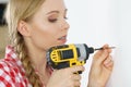 Woman drilling in wall Royalty Free Stock Photo