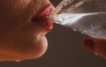 Woman drink cocktail. Close up wet sexy lips. Young girl drinking red lip cocktail closeup. Royalty Free Stock Photo