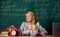 Woman drink coffee in classroom. teacher with alarm clock at blackboard. Time. Back to school. Teachers day. Study and Royalty Free Stock Photo