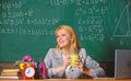 Woman drink coffee in classroom. teacher with alarm clock at blackboard. Time. Back to school. Teachers day. Study and Royalty Free Stock Photo