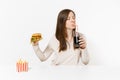 Woman drink cola from straw glass bottle, sitting at table with burger, french fries isolated on white background Royalty Free Stock Photo