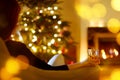 Woman with a drink by a fireplace on Christmas Royalty Free Stock Photo