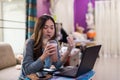 Woman drink ice chocolate, eat sandwich, and work at computer Royalty Free Stock Photo