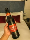 Woman drink London Pride ale in luxury hotel bedroom for celebration