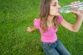 Woman drink water grass Royalty Free Stock Photo