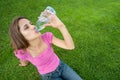 Woman drink water grass Royalty Free Stock Photo