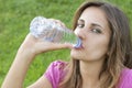 Woman drink water grass Royalty Free Stock Photo