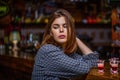 Woman drinking alcohol. Scotch whiskey glass isolated at bar or pub in alcohol abuse and alcoholic concept. Drunk woman