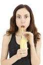 Woman drinking banana smoothie with a funny expression