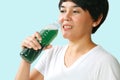 Woman drinking chlorophyll water