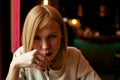 Woman drinking a cocktail from a straw in a cafe Royalty Free Stock Photo