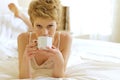 Woman drinking coffee in bed Royalty Free Stock Photo