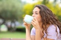 Woman drinking coffee on a bench Royalty Free Stock Photo