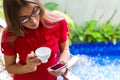 Woman drinking coffee checking Mails on phone