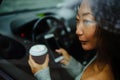 Woman drinking coffee while driving her car. Drinking morning coffee while driving to work. Royalty Free Stock Photo