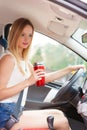 Woman drinking coffee while driving her car Royalty Free Stock Photo