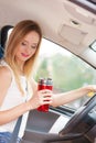 Woman drinking coffee while driving her car Royalty Free Stock Photo