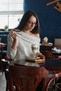 Woman drinking coffee in the morning at restaurant soft focus on the eyes Royalty Free Stock Photo