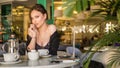 Woman drinking coffee in the morning at restaurant soft focus on the eyes Royalty Free Stock Photo
