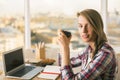 Woman drinking coffee in office Royalty Free Stock Photo