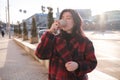 Woman drinking coffee in the sun, outdoor in sunlight light, enjoying her morning coffee. Royalty Free Stock Photo