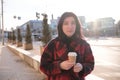 Woman drinking coffee in the sun, outdoor in sunlight light, enjoying her morning coffee. Royalty Free Stock Photo