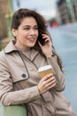 Woman Drinking Coffee Talking on Cell Phone, London, England Royalty Free Stock Photo