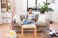 Woman drinking coffee or tea after cleaning home Royalty Free Stock Photo