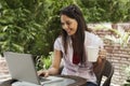 Woman drinking coffee and using a laptop Royalty Free Stock Photo