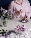 Woman drinking coffee with violet sweet Zephyr Marshmallow