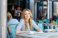 Woman drinking coffee and writing notes in cafe Royalty Free Stock Photo