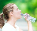 Woman drinking cold mineral water from a bottle after fitness ex Royalty Free Stock Photo