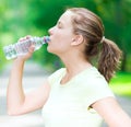 Woman drinking cold mineral water from a bottle Royalty Free Stock Photo