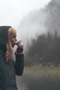 Woman drinking a cup of coffee in outdoor setting