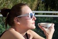 Woman Drinking A Cup Of Coffee Outdoors In The Sun Royalty Free Stock Photo