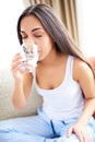 Woman drinking glass of water leaning forward. Royalty Free Stock Photo