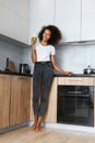 Woman drinking green detox juice, smoothie drink in kitchen Royalty Free Stock Photo